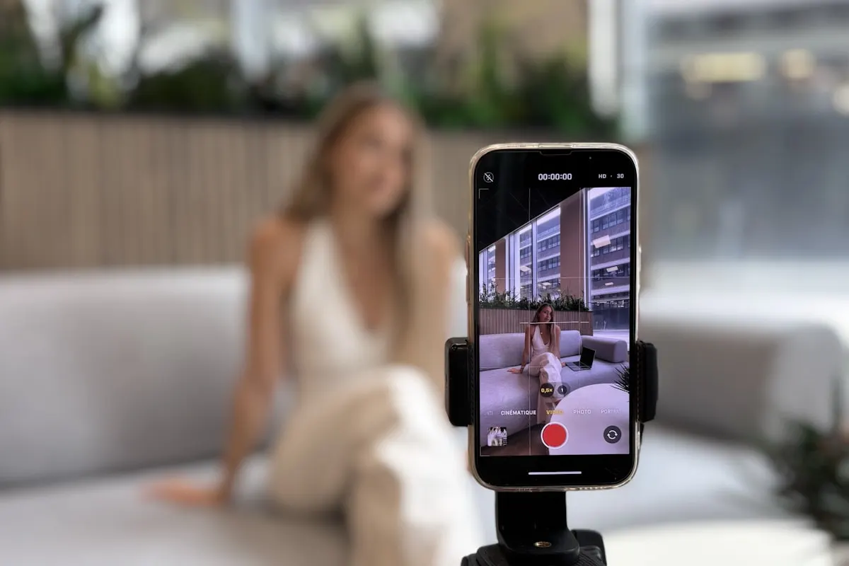 Criadora gravando vídeo com smartphone em tripé para redes sociais